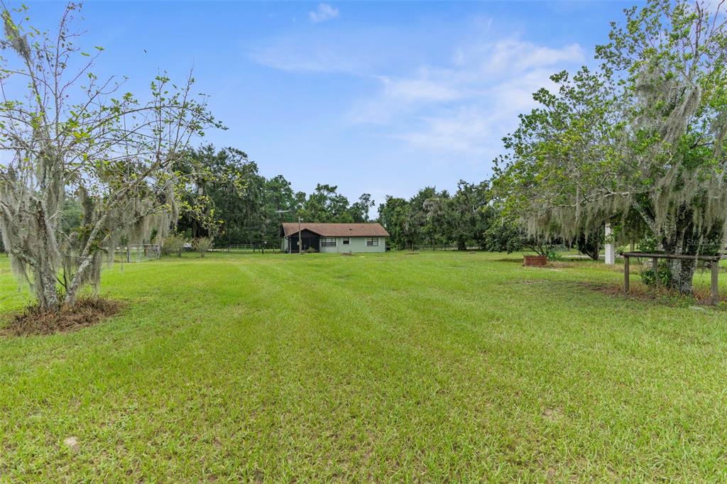 22249 Powell Road Brooksville, FL 34601 - Photo 36 of 43 a backyard of a house with lots of green space
