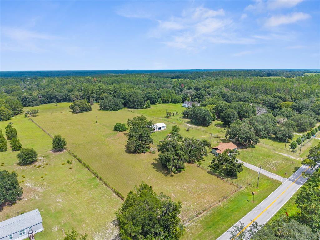 22249 Powell Road Brooksville, FL 34601 - Photo 4 of 43 an aerial view of a houses with trees