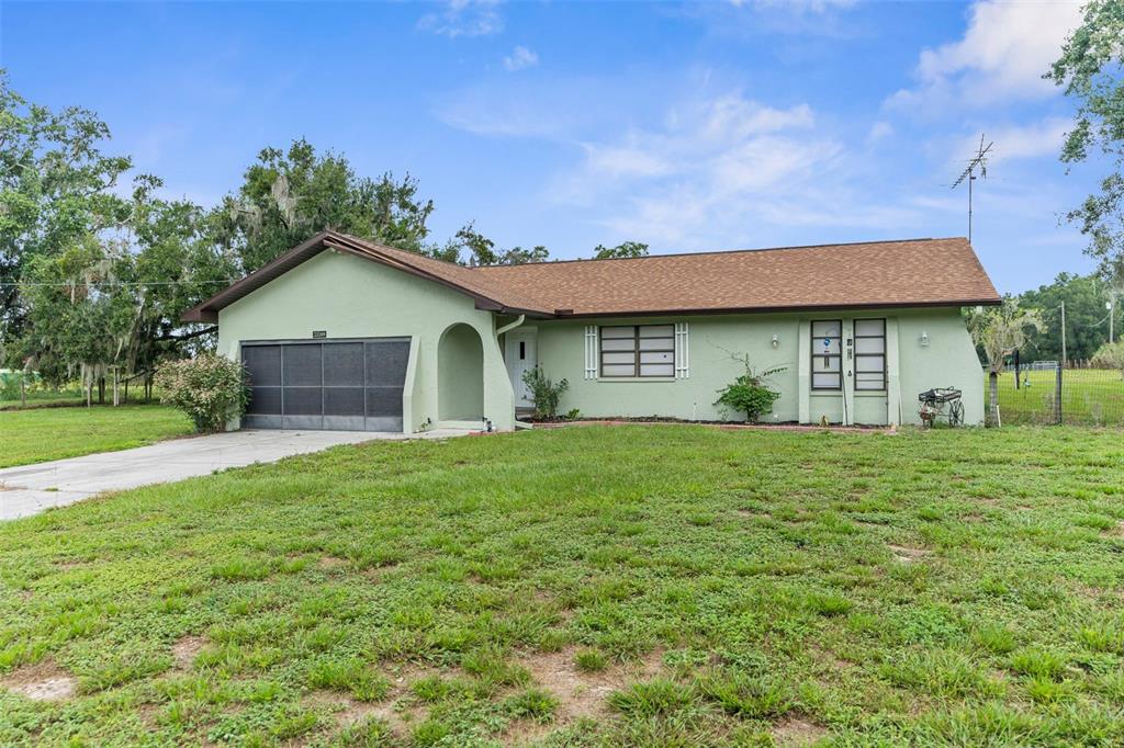 22249 Powell Road Brooksville, FL 34601 - Photo 41 of 43 a view of a house with a yard