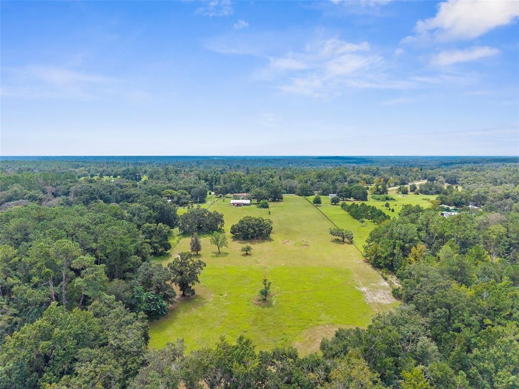 22249 Powell Road Brooksville, FL 34601 - Photo 5 of 43 an aerial view of residential houses with outdoor space and trees