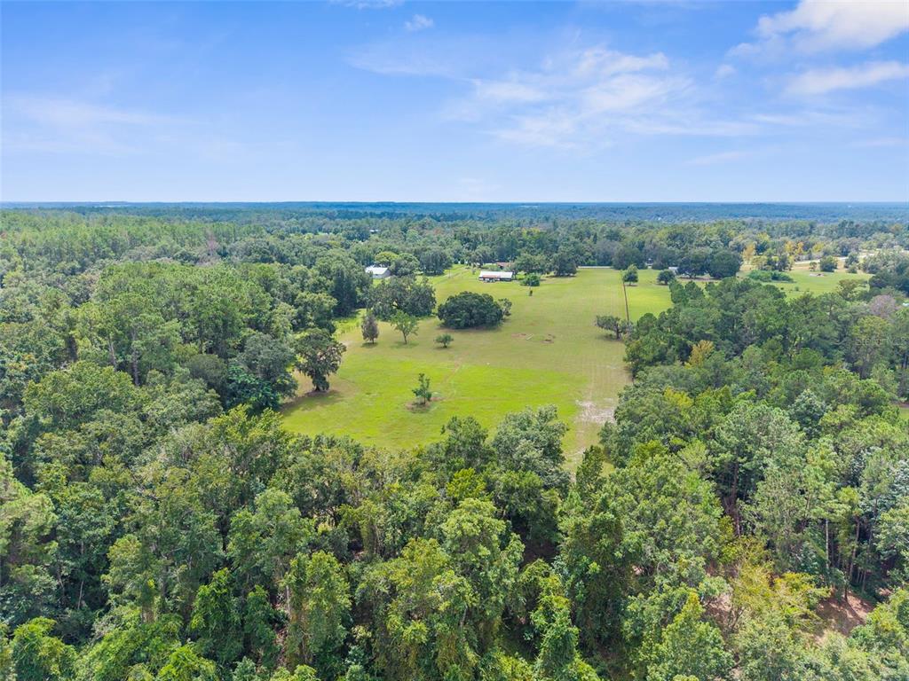 22249 Powell Road Brooksville, FL 34601 - Photo 9 of 43 an aerial view of a houses with outdoor space and seating