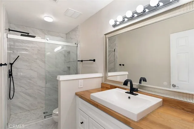 a bathroom with a sink double vanity and a mirror