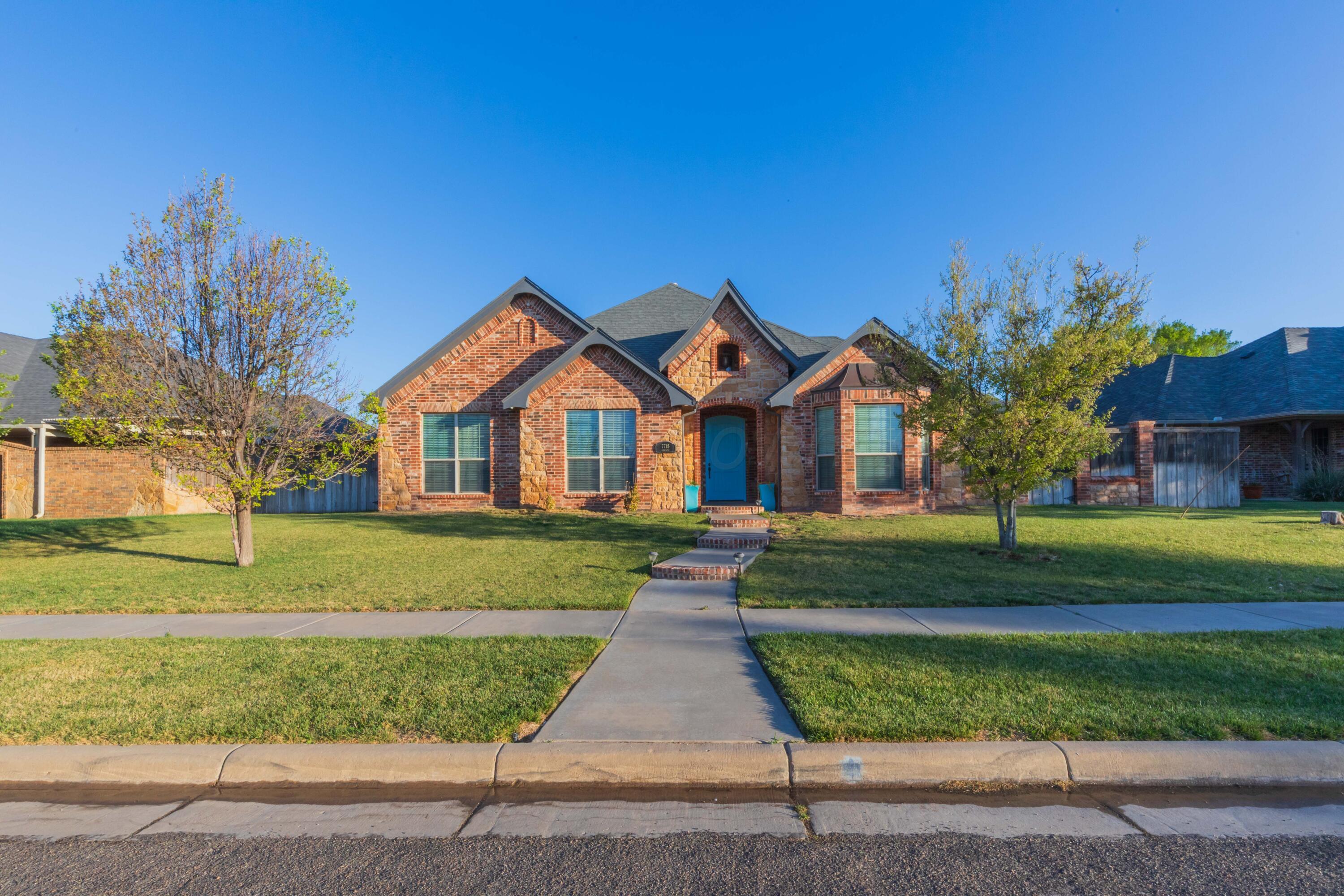 7718 Pinnacle Drive Amarillo, TX 79119 - Photo 1 of 66 a front view of a house with a yard