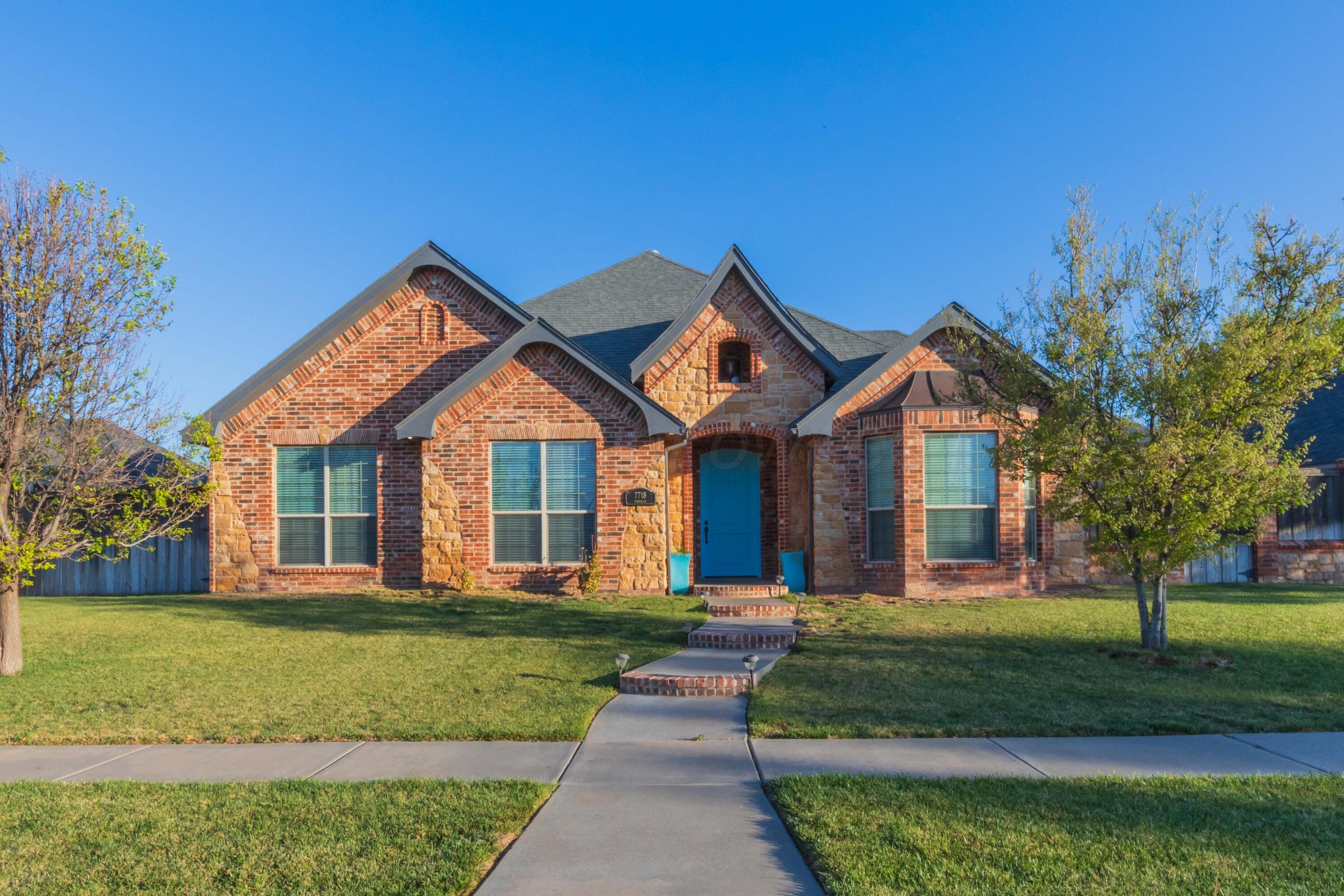 7718 Pinnacle Drive Amarillo, TX 79119 - Photo 2 of 66 a front view of a house with a yard