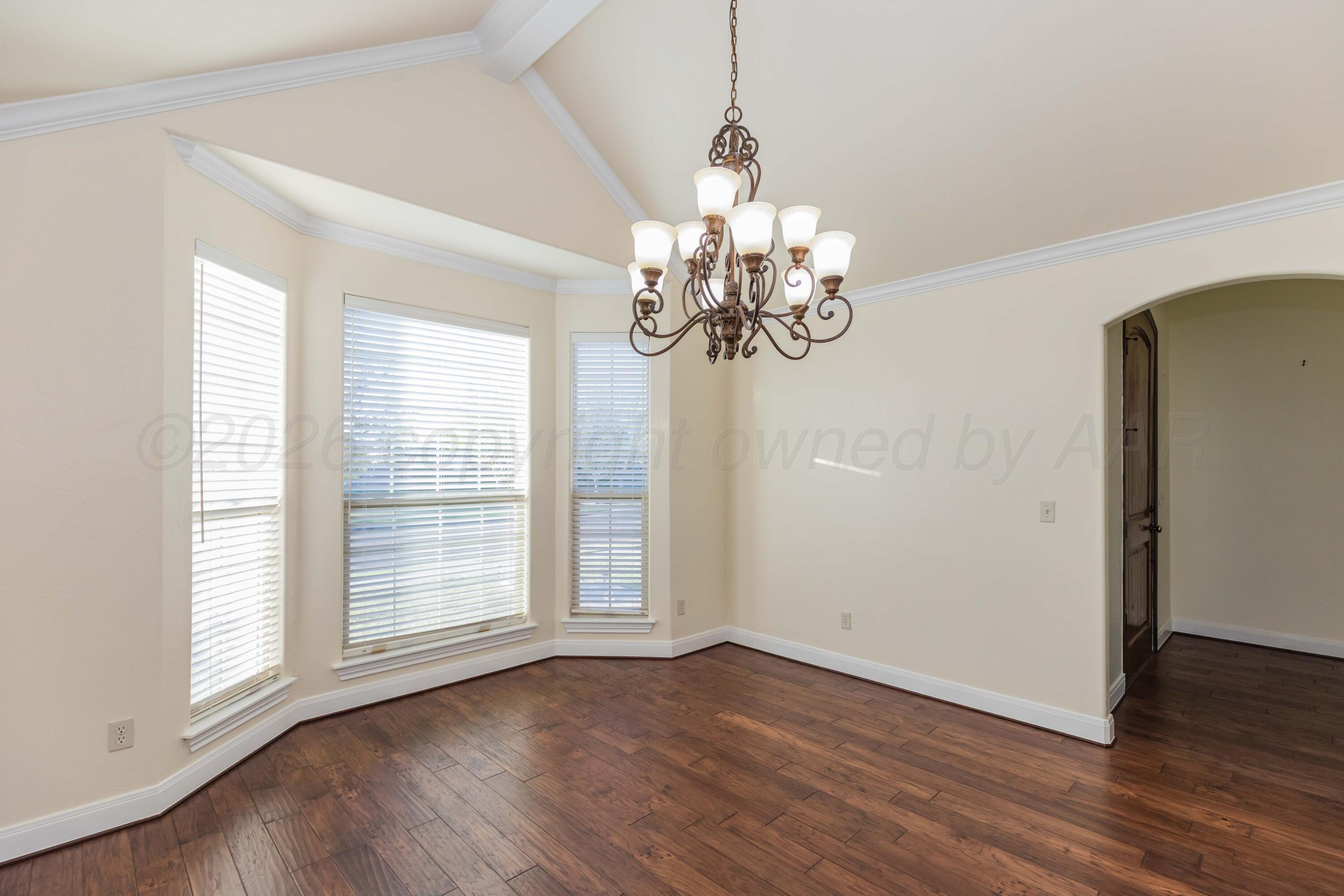 7718 Pinnacle Drive Amarillo, TX 79119 - Photo 23 of 66 a view of a chandelier in big room with wooden floor and chandelier