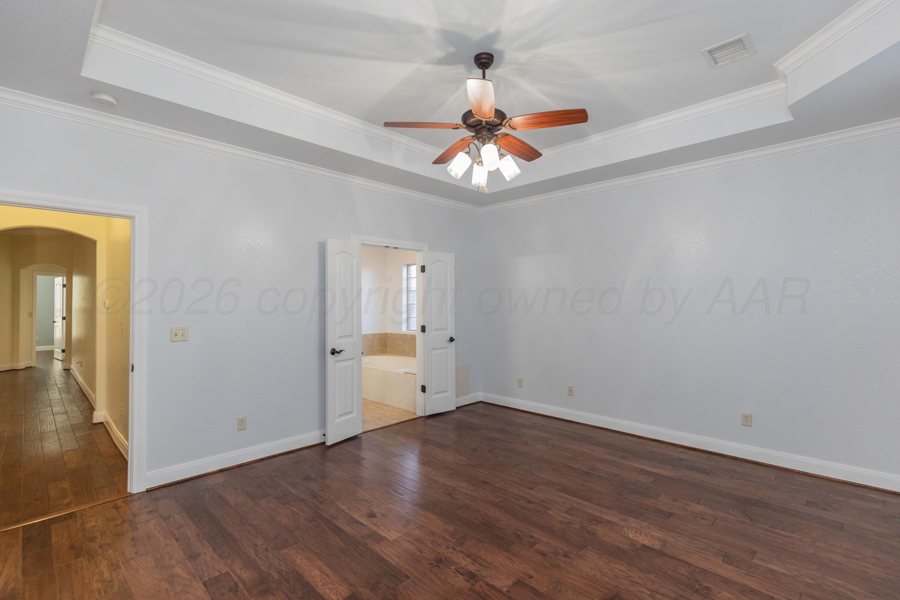 7718 Pinnacle Drive Amarillo, TX 79119 - Photo 27 of 66 wooden floor in an empty room with a window
