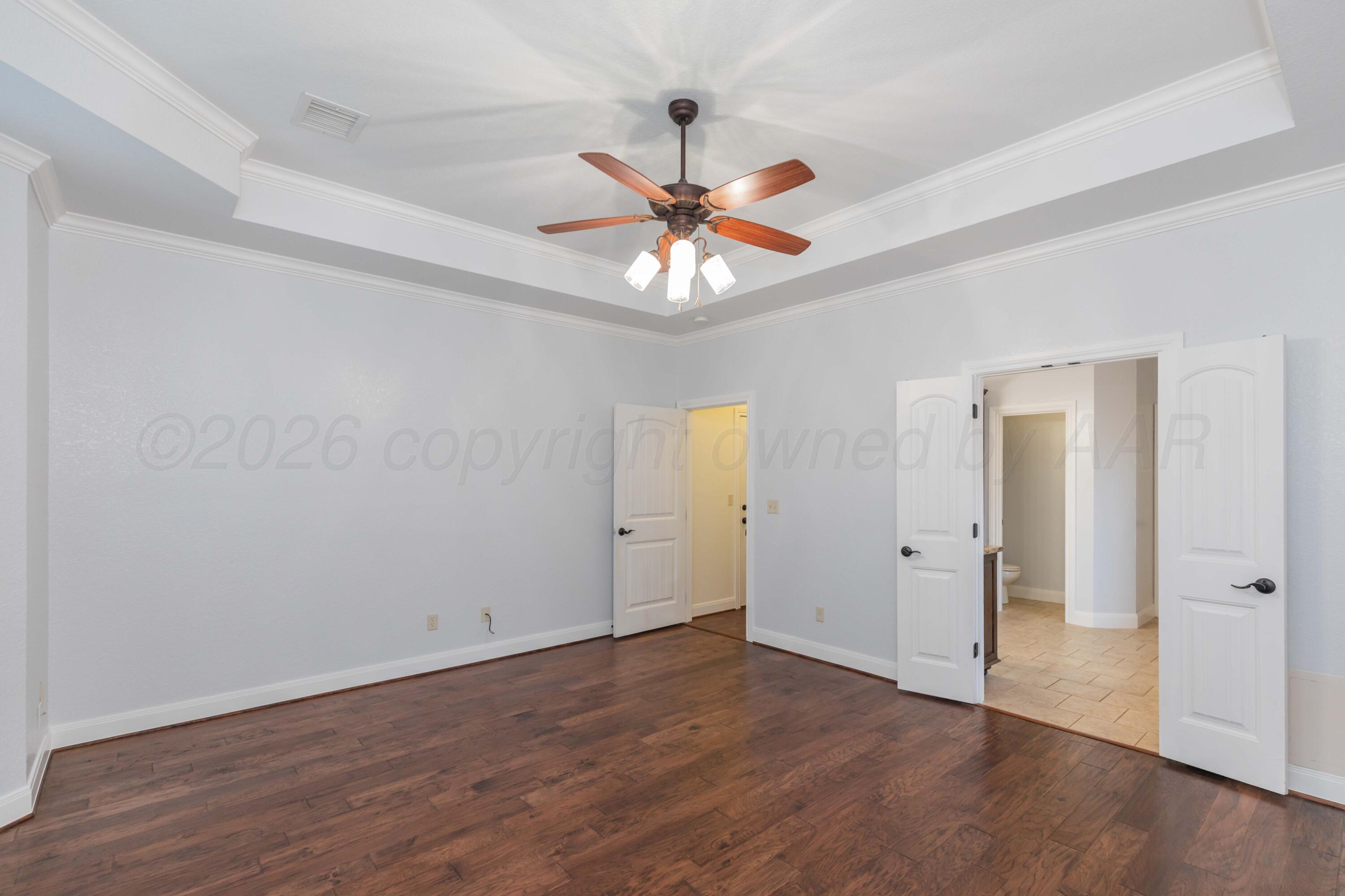 7718 Pinnacle Drive Amarillo, TX 79119 - Photo 28 of 66 an empty room with wooden floor closet fan and windows