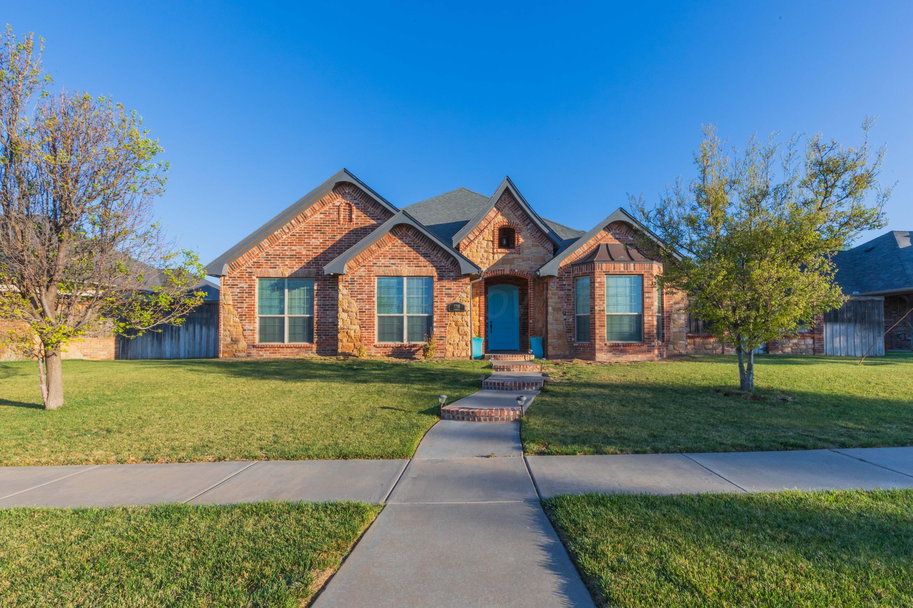 7718 Pinnacle Drive Amarillo, TX 79119 - Photo 3 of 66 a front view of a house with a yard