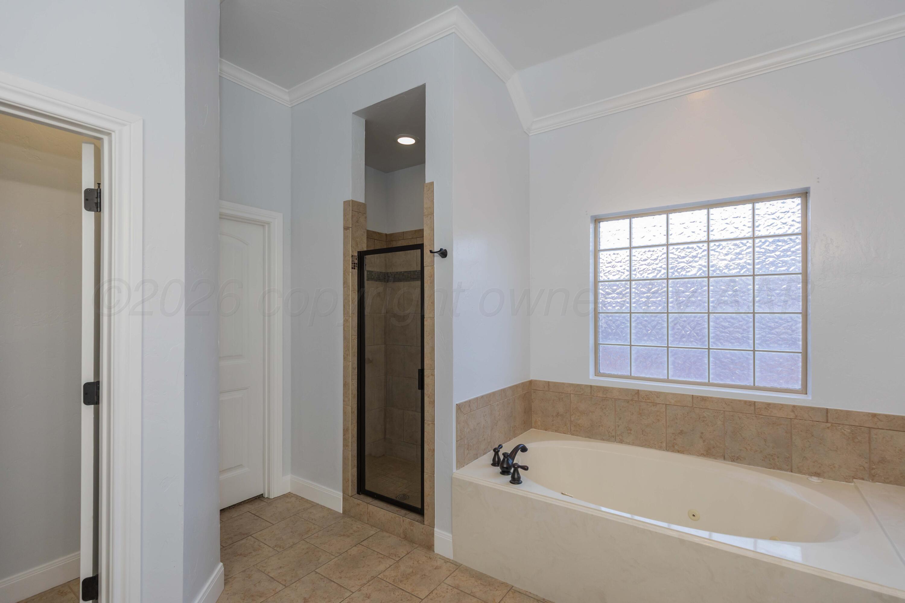 7718 Pinnacle Drive Amarillo, TX 79119 - Photo 32 of 66 a bathroom with a bathtub and shower