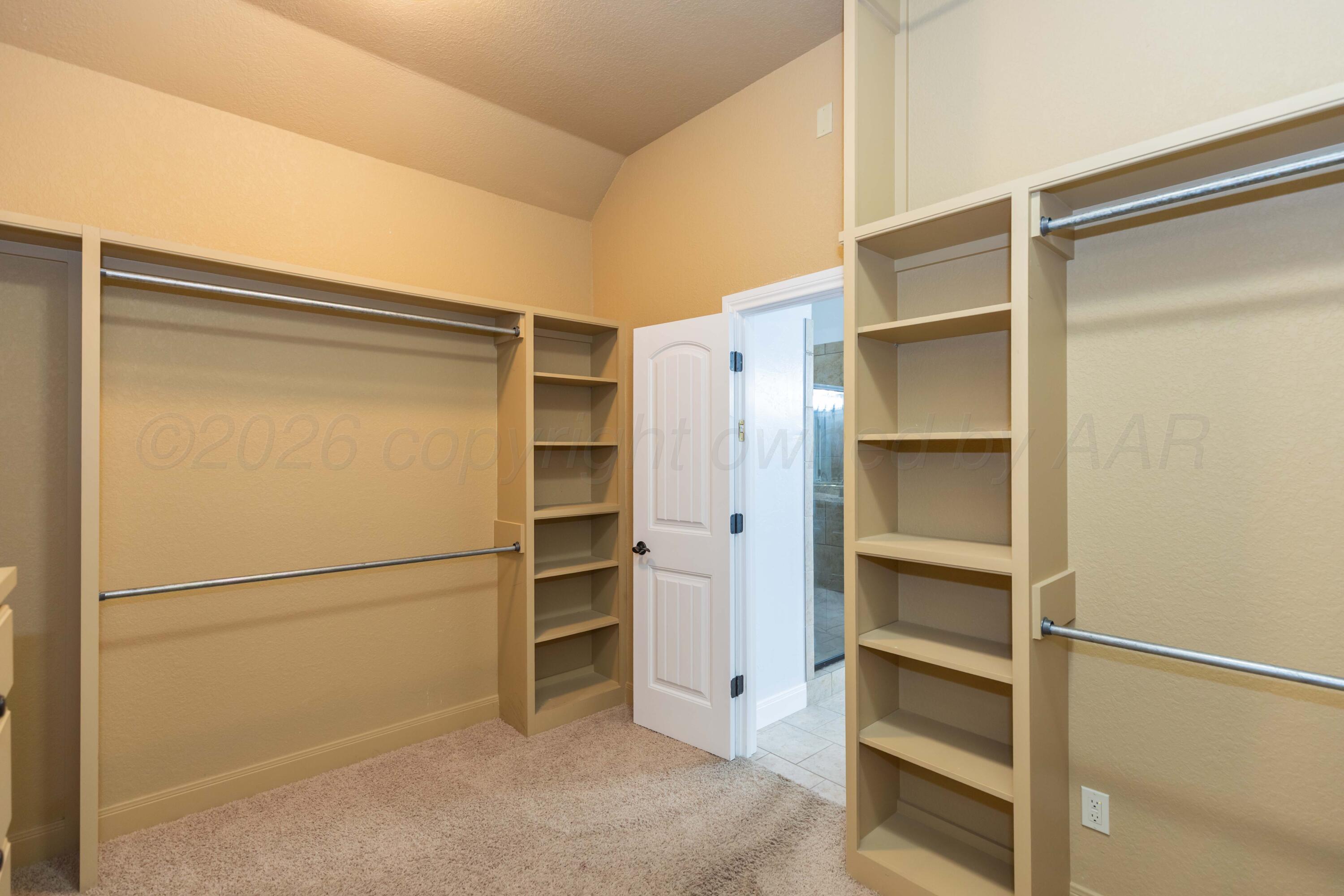 7718 Pinnacle Drive Amarillo, TX 79119 - Photo 35 of 66 a view of walk in closet with empty racks