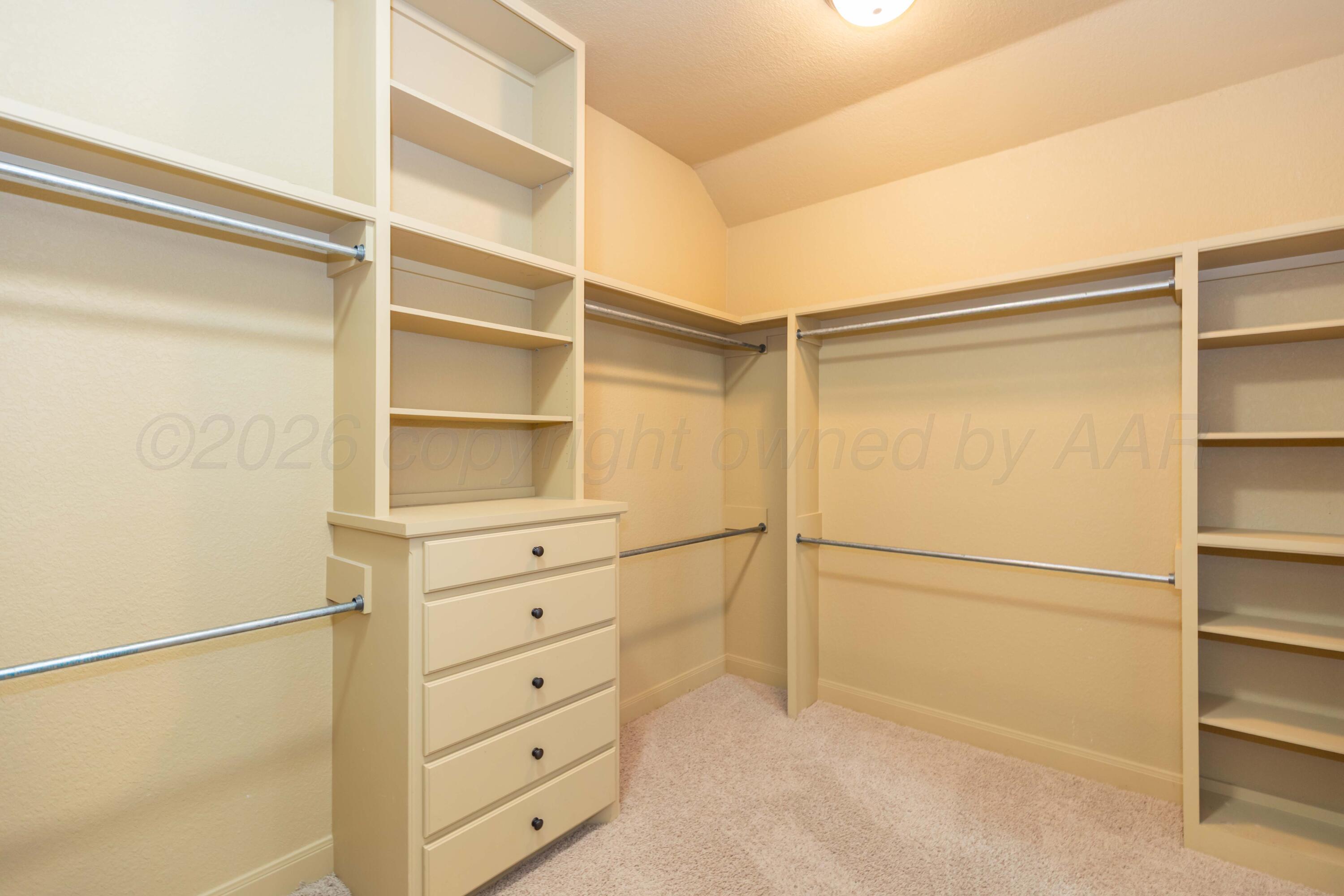 7718 Pinnacle Drive Amarillo, TX 79119 - Photo 36 of 66 a view of walk in closet with empty racks