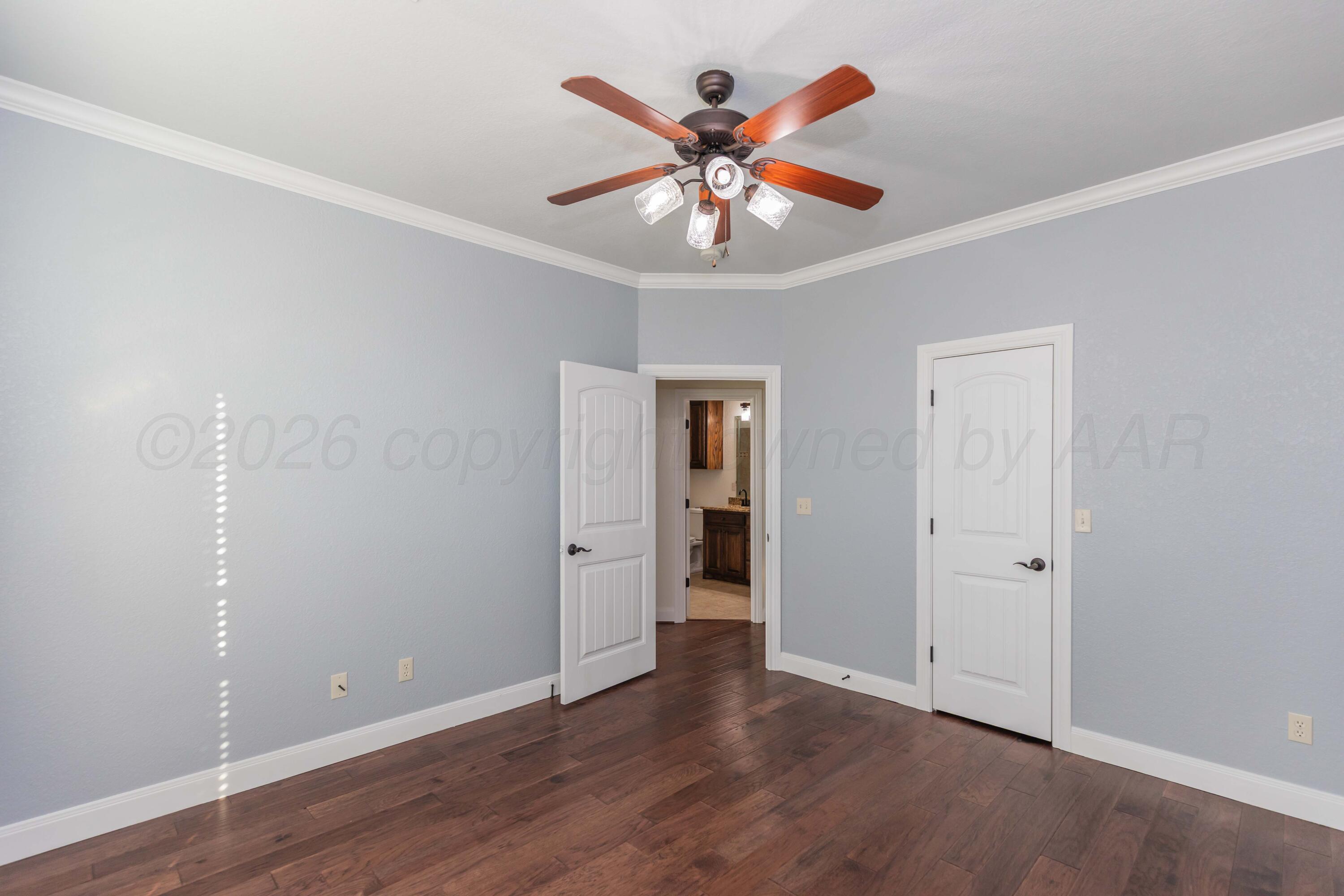 7718 Pinnacle Drive Amarillo, TX 79119 - Photo 39 of 66 an empty room with wooden floor and ceiling fan