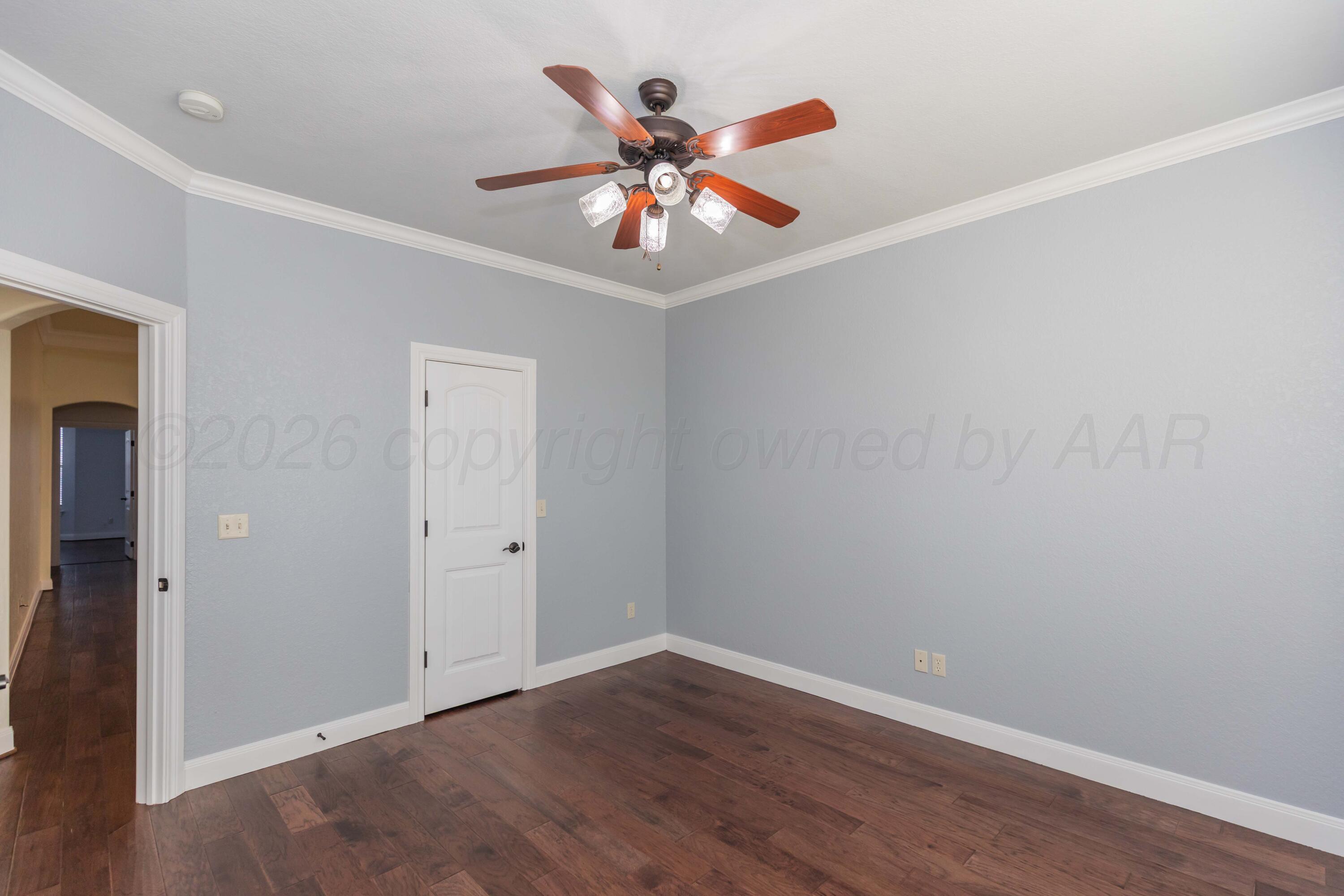 7718 Pinnacle Drive Amarillo, TX 79119 - Photo 40 of 66 a view of an empty room with window and wooden floor