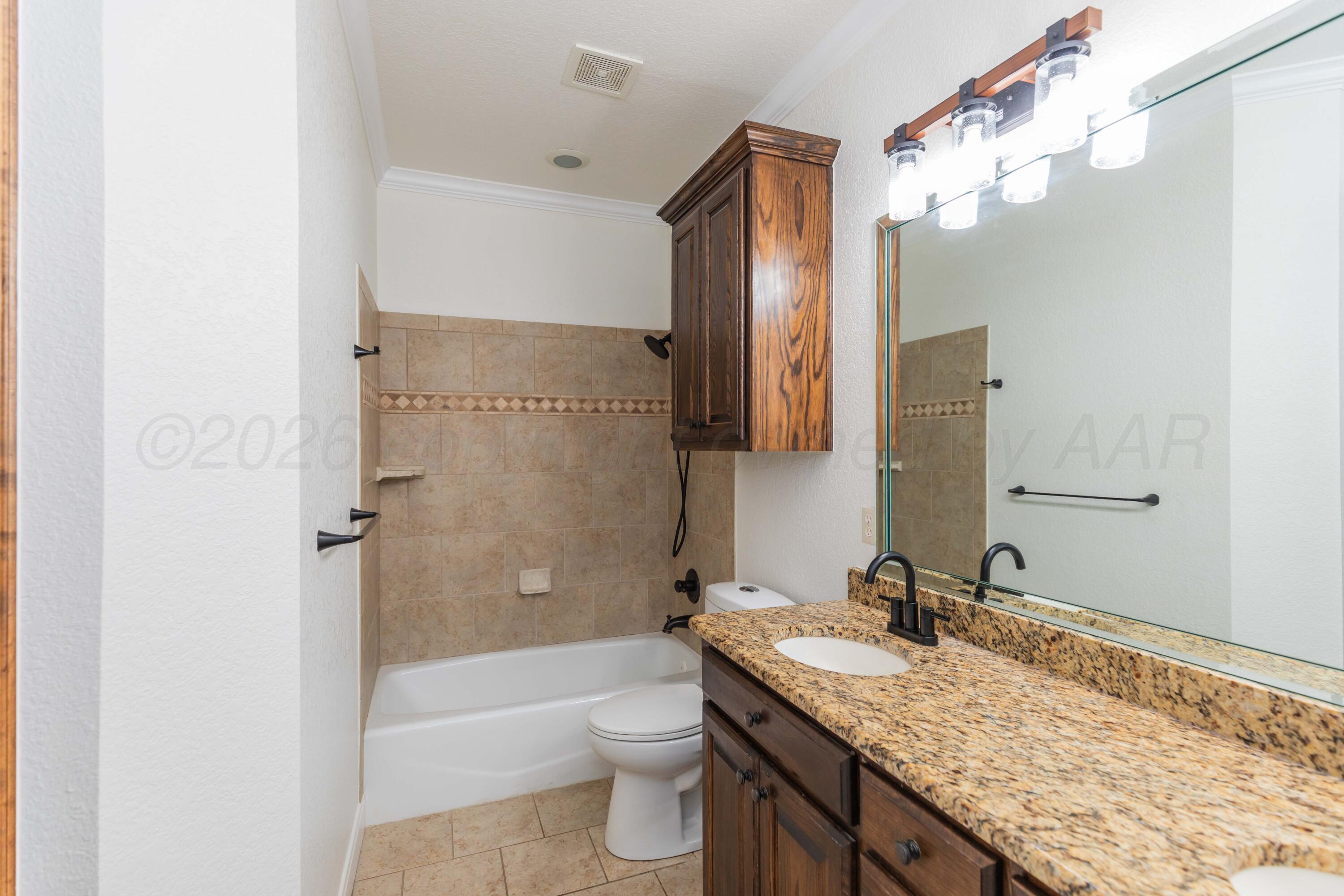 7718 Pinnacle Drive Amarillo, TX 79119 - Photo 41 of 66 a bathroom with a granite countertop sink toilet and shower