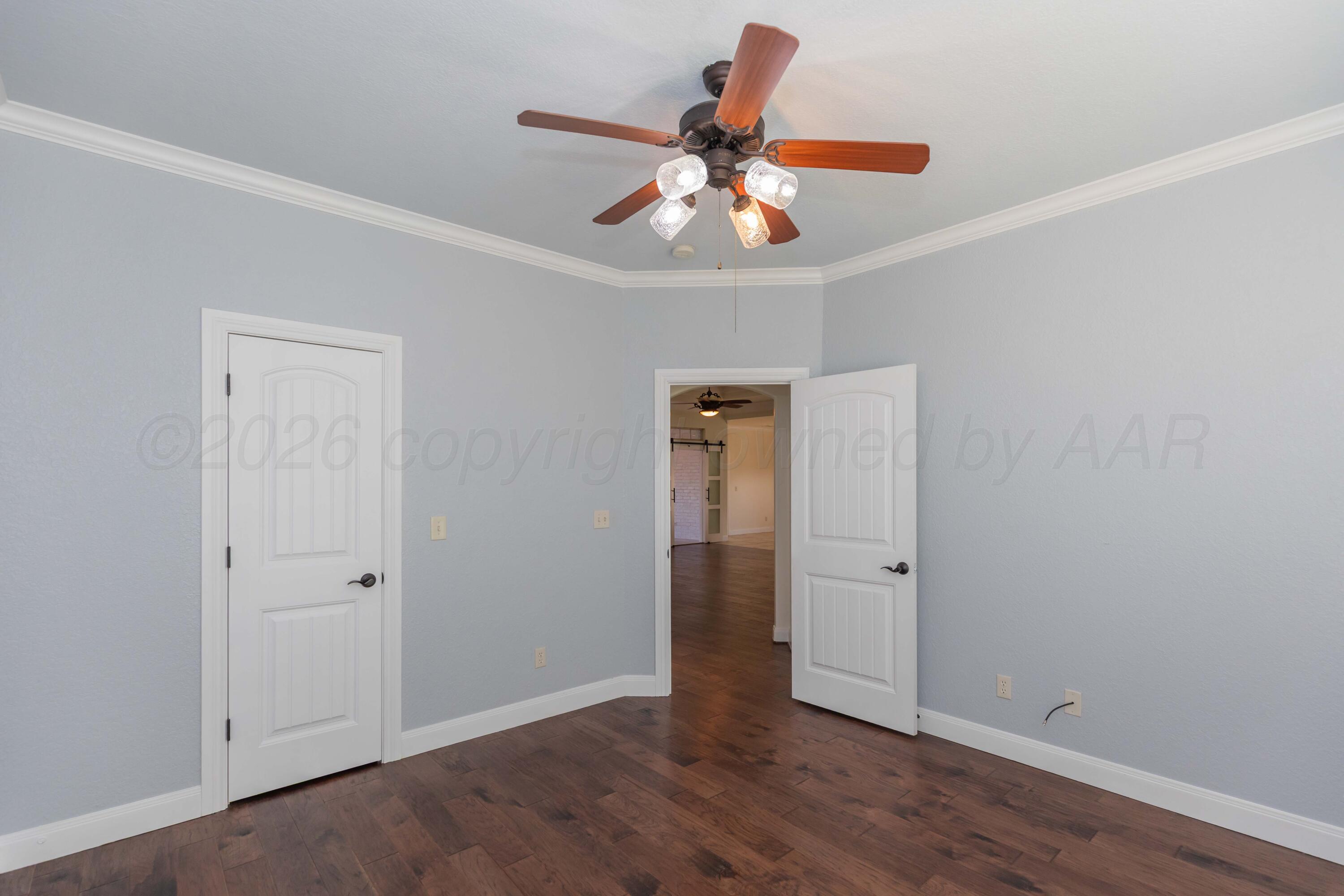 7718 Pinnacle Drive Amarillo, TX 79119 - Photo 46 of 66 an empty room with wooden floor closet and ceiling fan