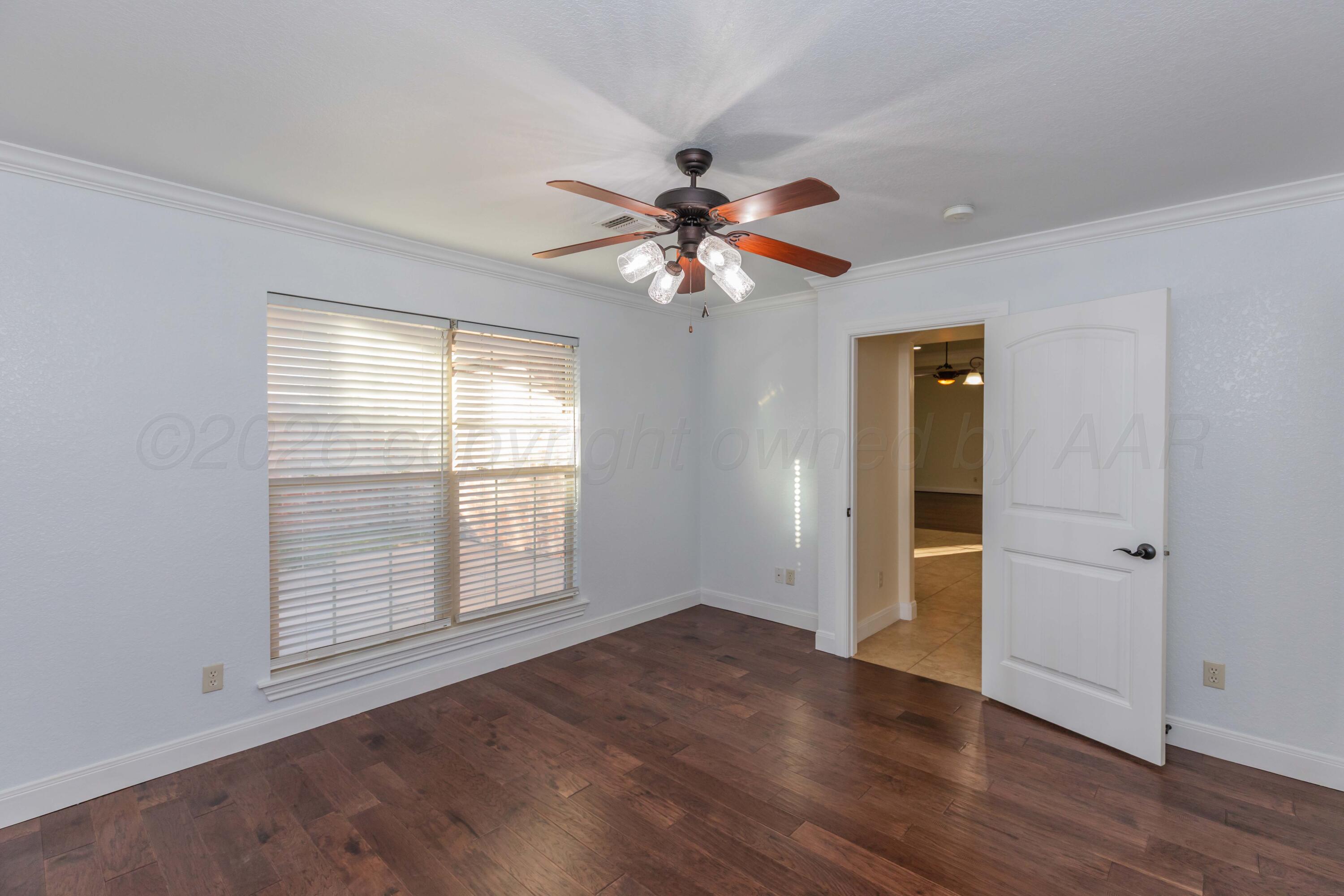 7718 Pinnacle Drive Amarillo, TX 79119 - Photo 48 of 66 wooden floor in an empty room with a window