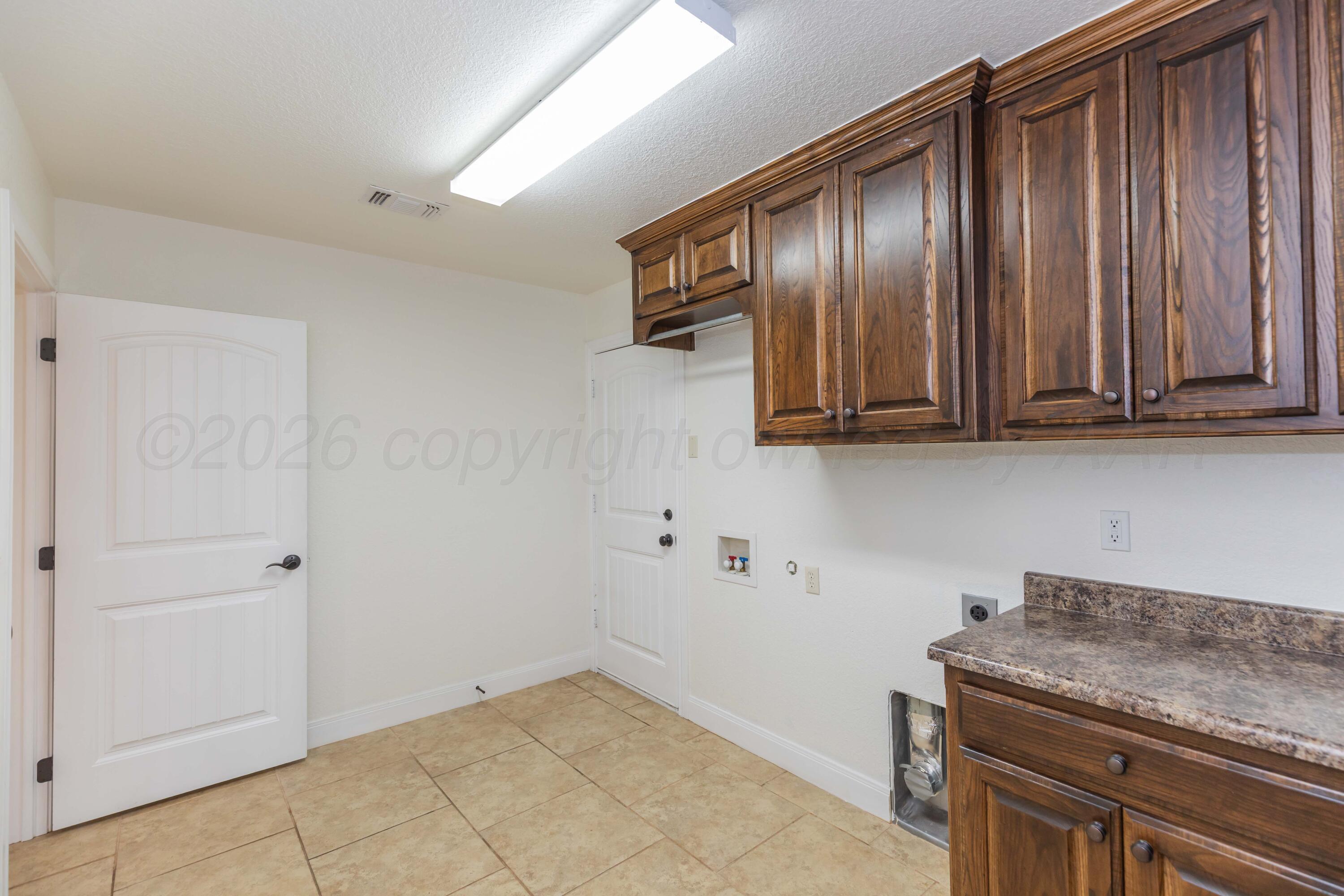 7718 Pinnacle Drive Amarillo, TX 79119 - Photo 56 of 66 a view of a kitchen with stainless steel appliances granite countertop cabinets and a wooden floor