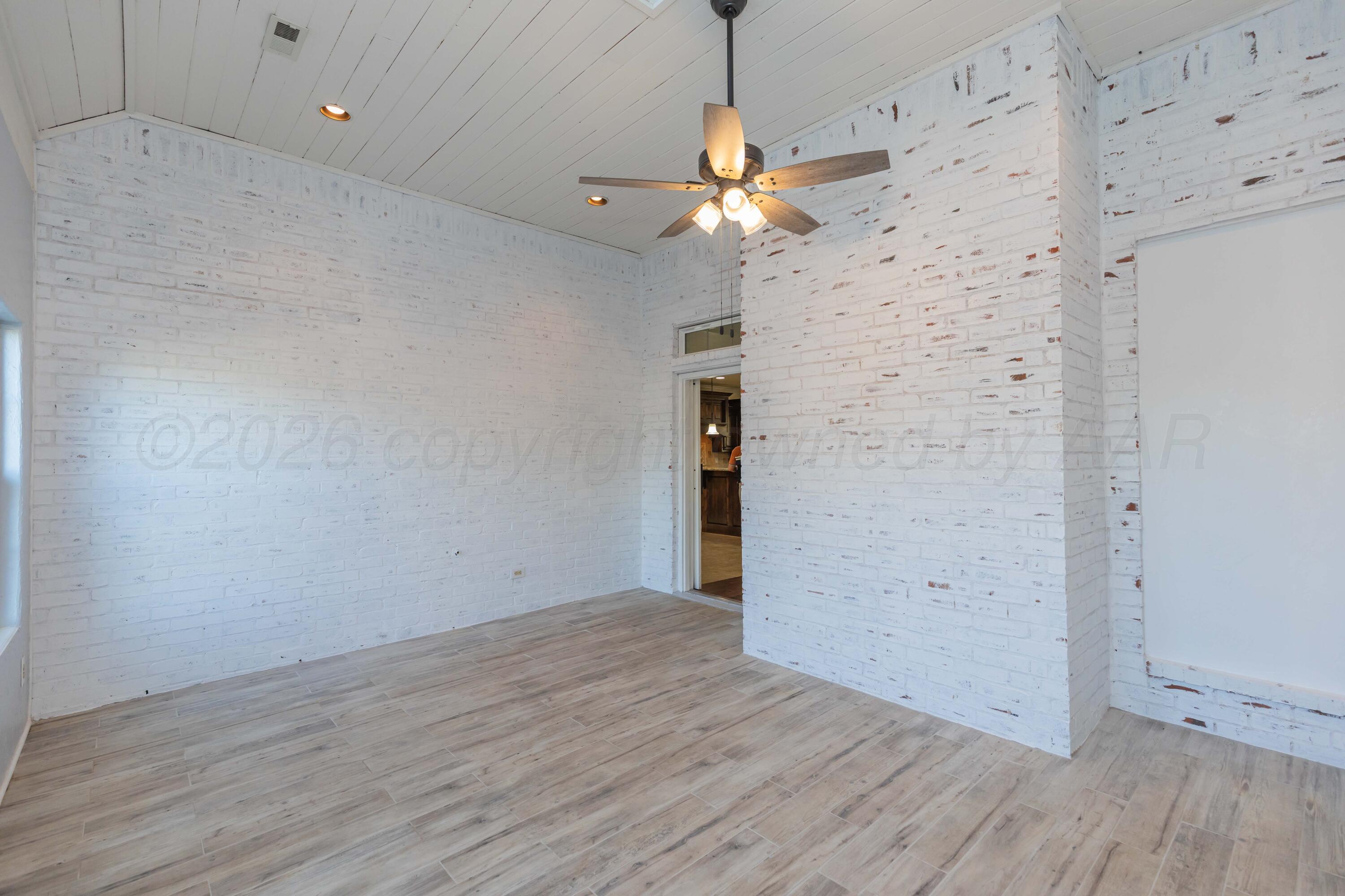 7718 Pinnacle Drive Amarillo, TX 79119 - Photo 58 of 66 an empty room with wooden floor chandelier fan and closet