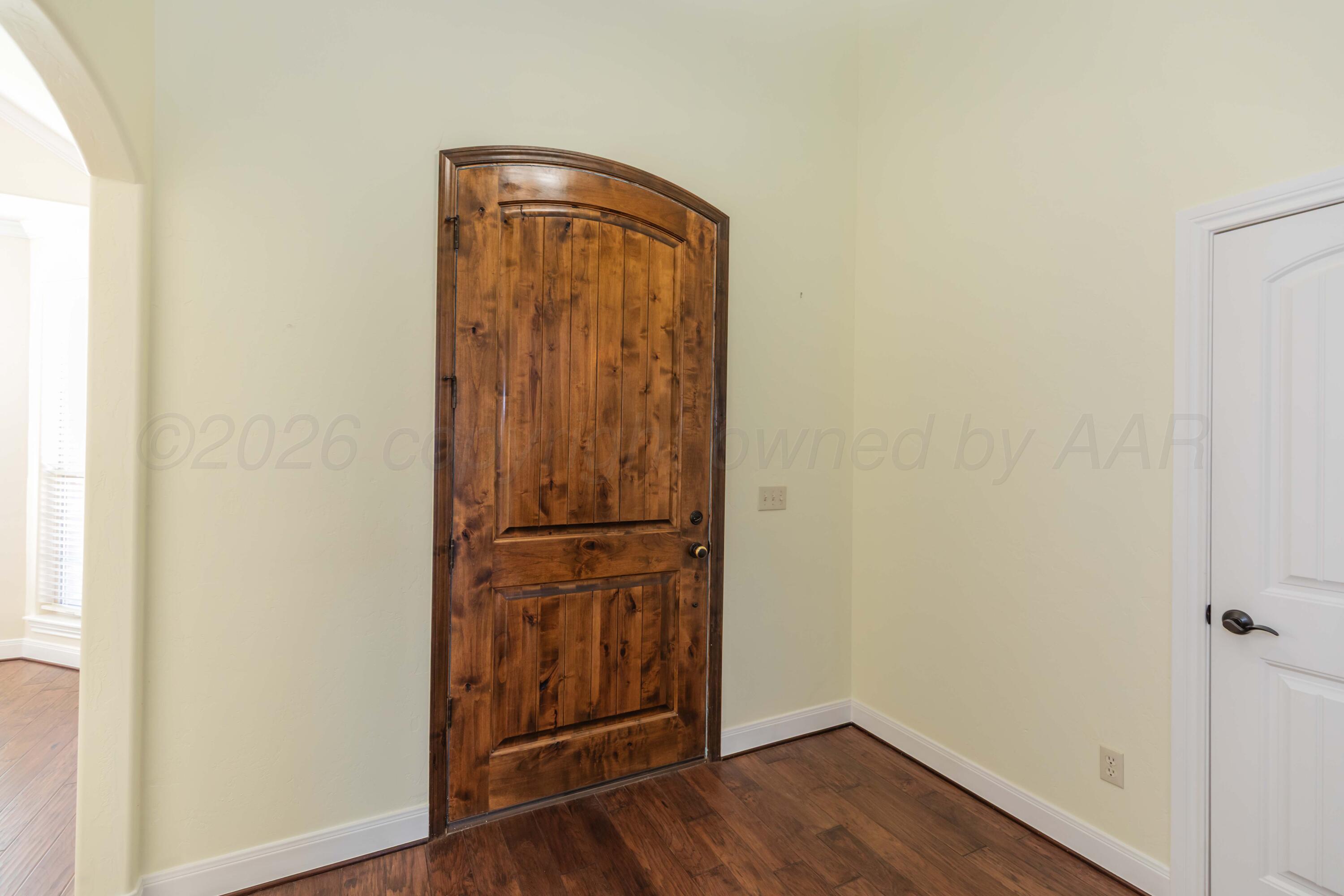 7718 Pinnacle Drive Amarillo, TX 79119 - Photo 7 of 66 a view of walk in closet with wooden floor
