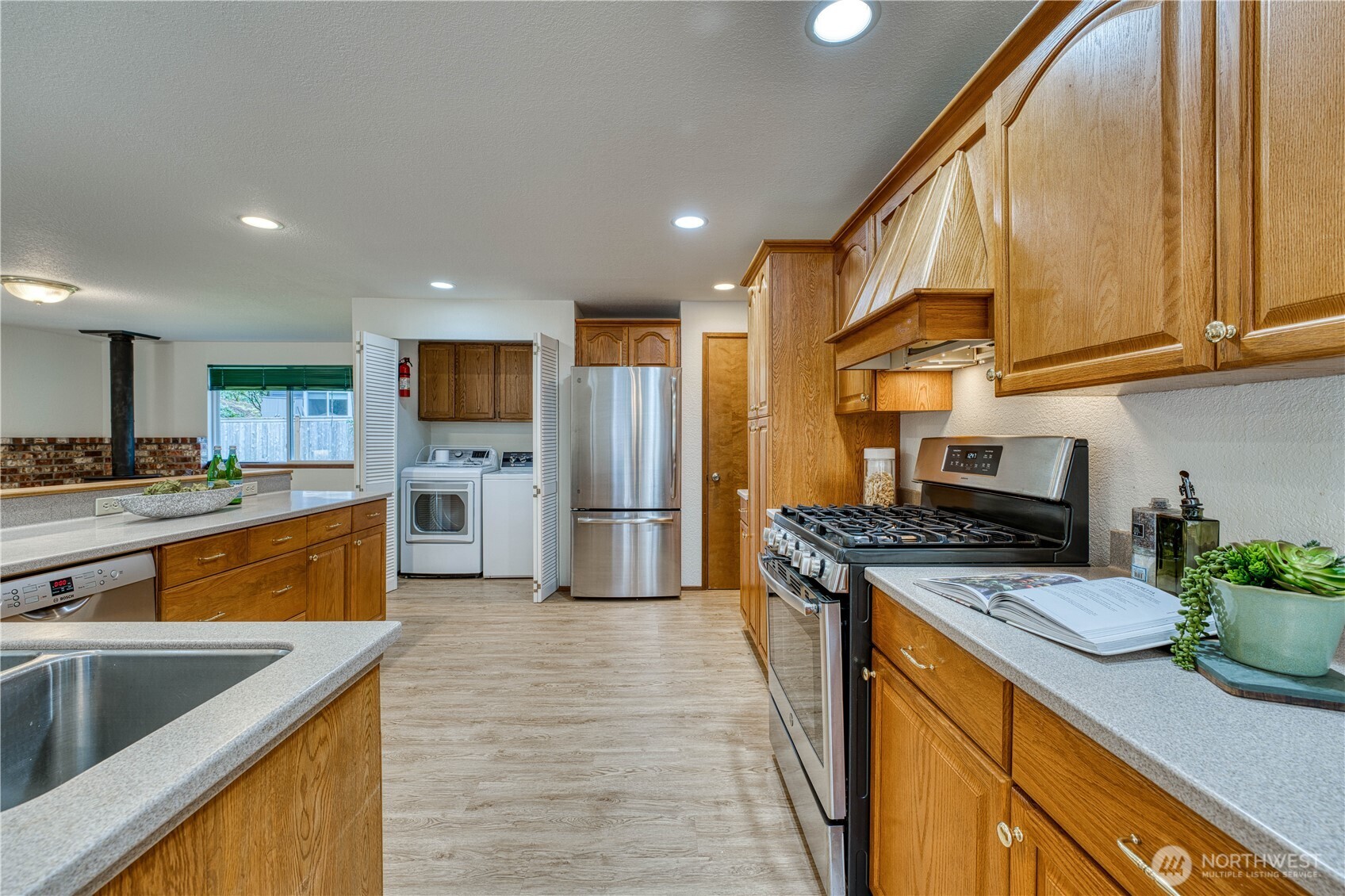 23823 90th Place West Edmonds, WA 98026 - Photo 16 of 40 a kitchen with stainless steel appliances granite countertop a sink a stove and a refrigerator