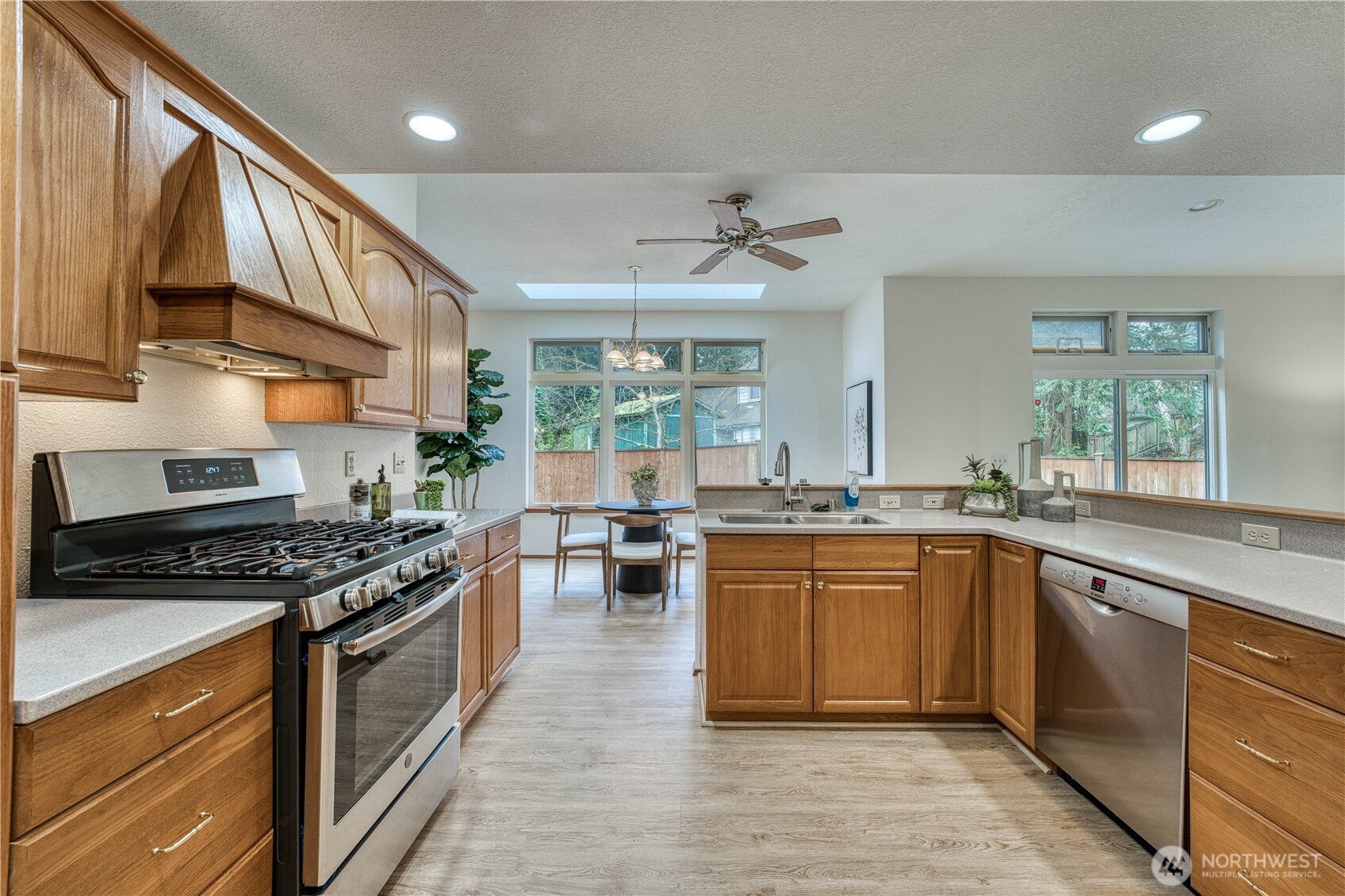 23823 90th Place West Edmonds, WA 98026 - Photo 18 of 40 a kitchen with stainless steel appliances granite countertop a stove a sink dishwasher and a refrigerator