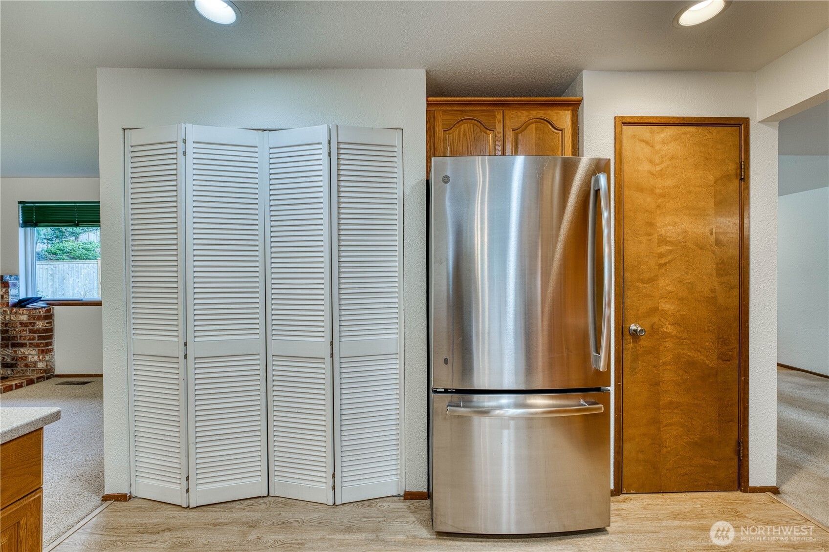 23823 90th Place West Edmonds, WA 98026 - Photo 21 of 40 a view of a refrigerator in kitchen and wooden floor