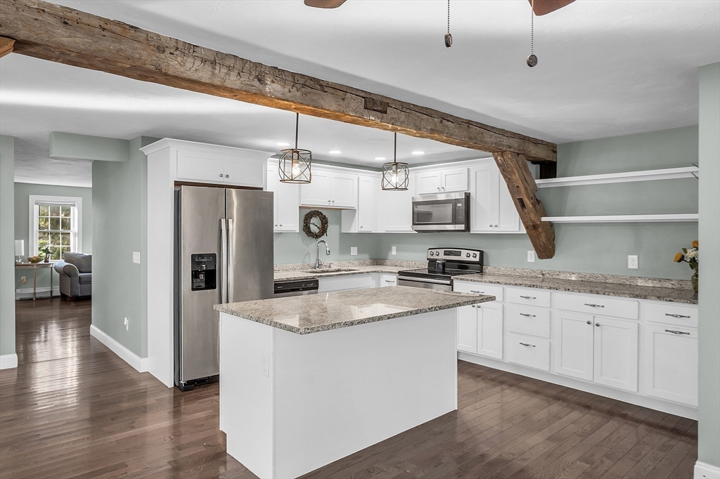 20 Main Street Ashburnham, MA 01430 - Photo 23 of 42 a kitchen with granite countertop a sink stainless steel appliances and cabinets