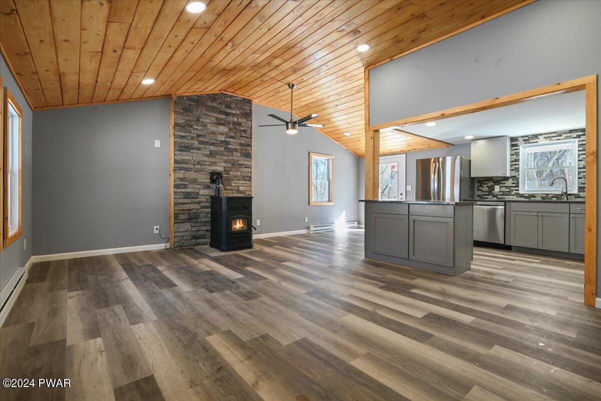 166 Skyview Road Dingmans Ferry, PA 18328 - Photo 8 of 44 a view of a living room and kitchen with furniture and wooden floor