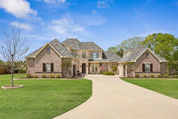 a front view of house with yard and green space