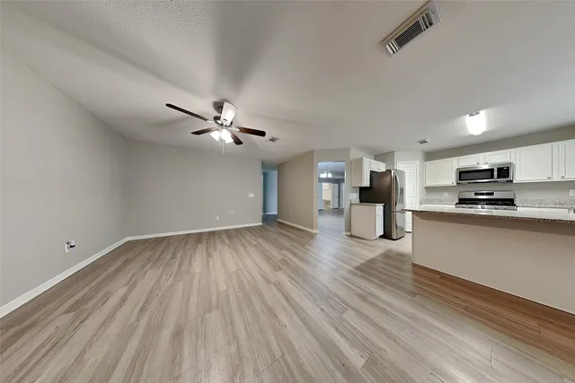a view of a kitchen with a sink and cabinets