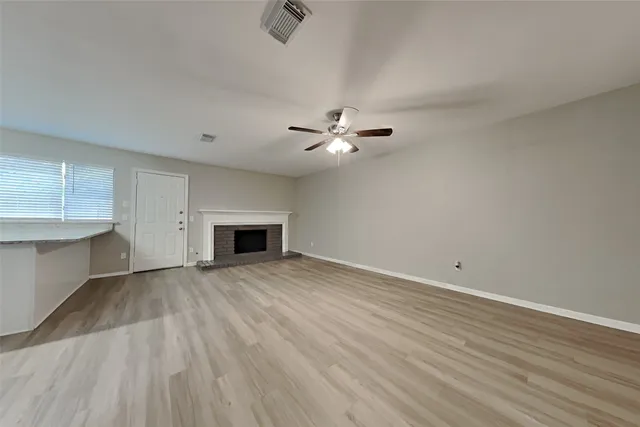 wooden floor in an empty room with a fireplace
