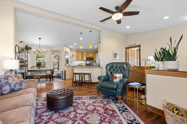 a living room with furniture a rug and a chandelier