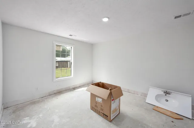 a view of bathroom with a sink and a mirror