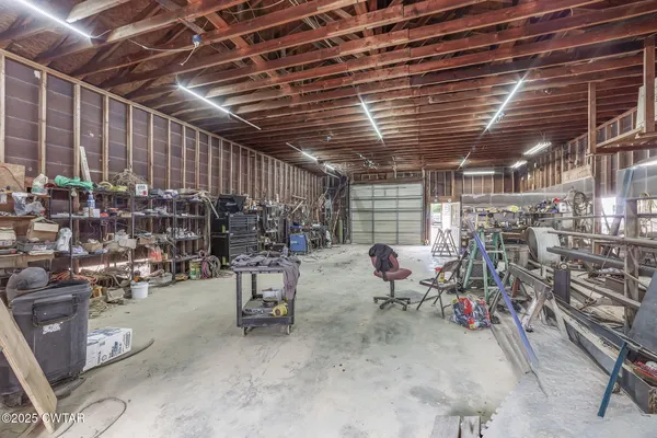 a living room with furniture a chandelier and a wooden floor