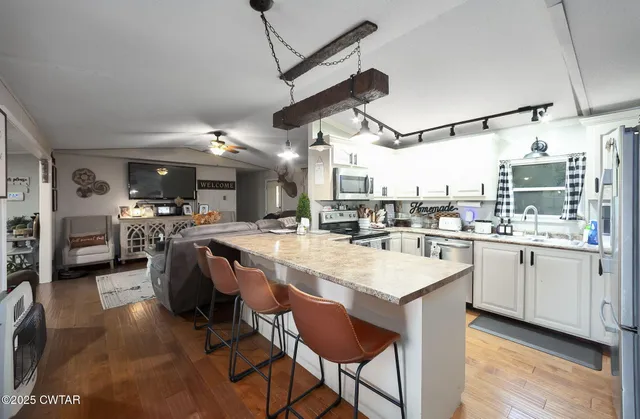 a spacious bedroom with a bed and a chandelier