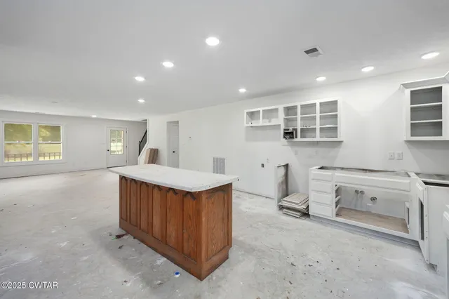 a kitchen with stainless steel appliances granite countertop a stove and a refrigerator