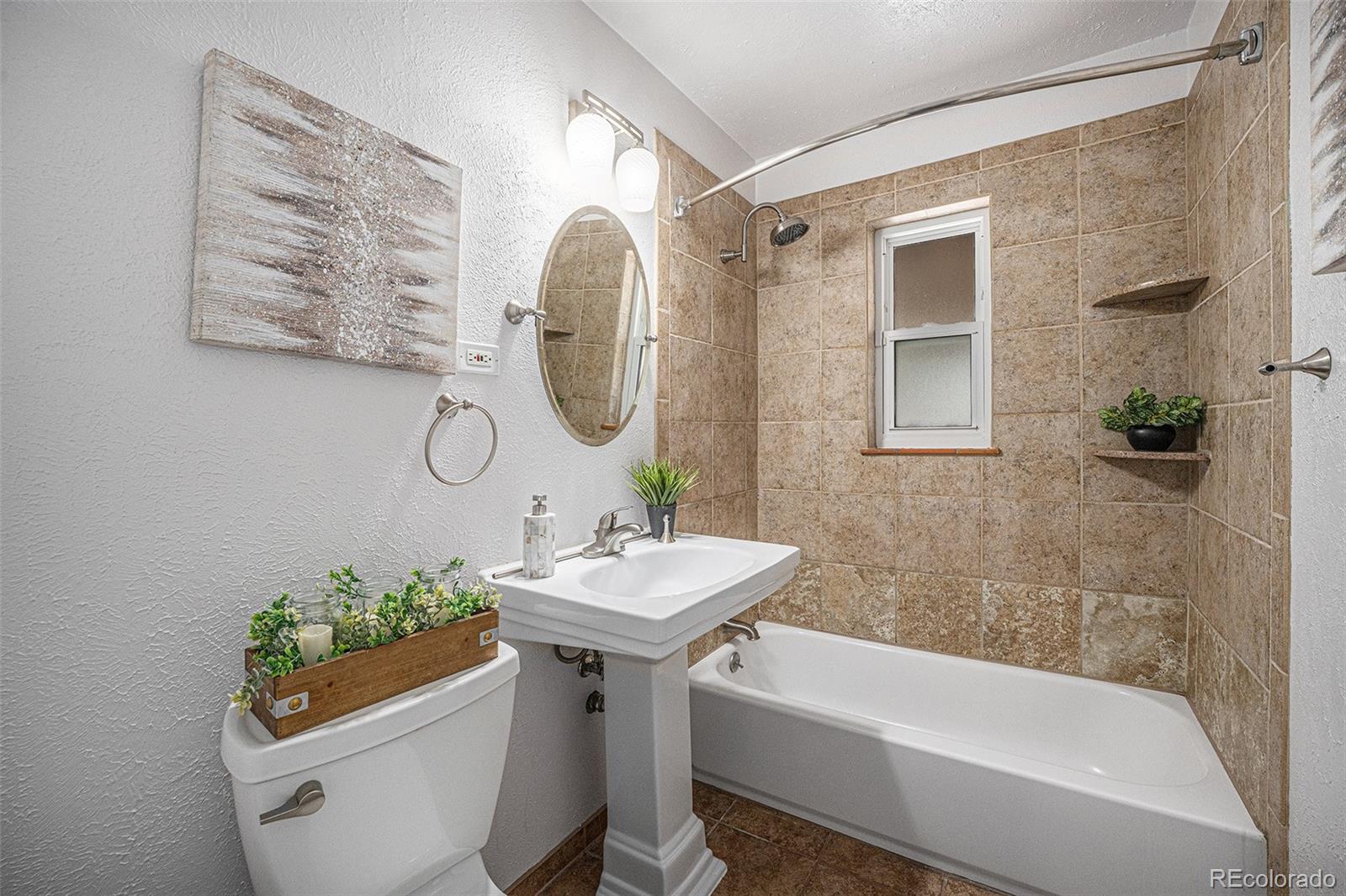 2141 Quebec Street Denver, CO 80207 - Photo 17 of 36 a bathroom with a sink toilet and shower