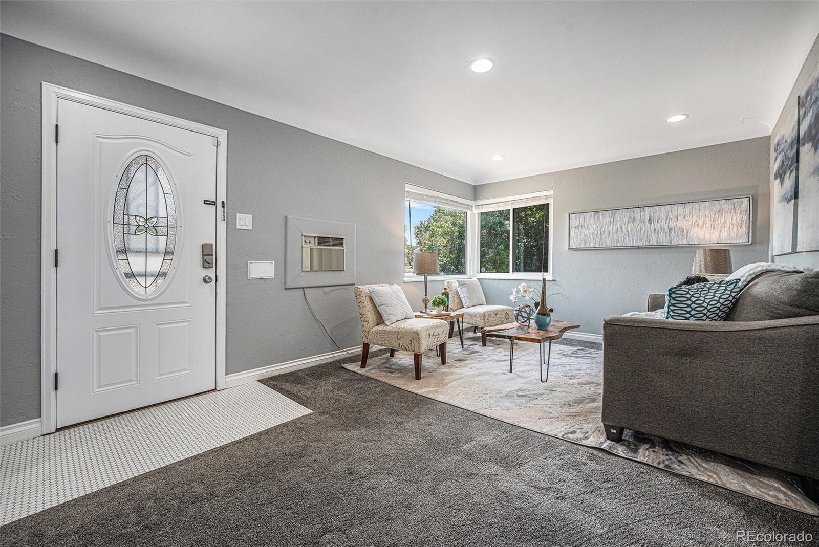 2141 Quebec Street Denver, CO 80207 - Photo 8 of 36 a living room with furniture and a window