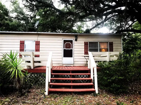 a front view of house with a garden