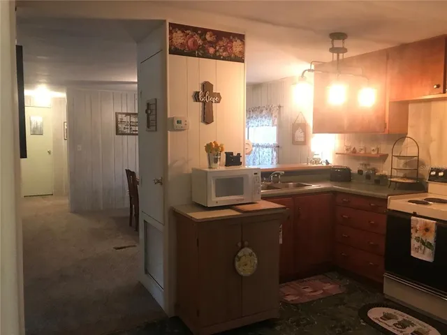 a kitchen with sink cabinets and appliances