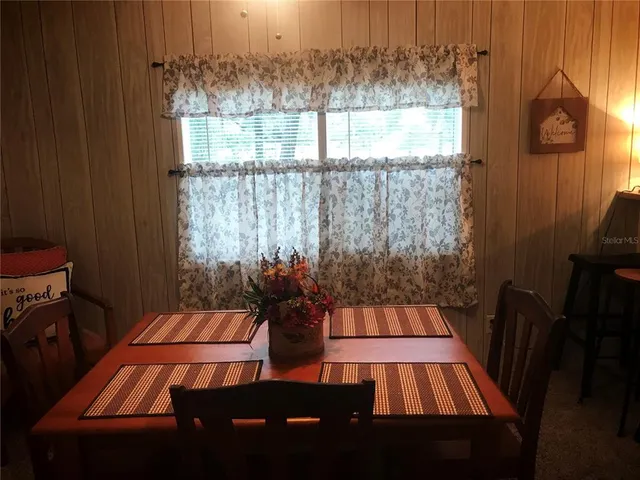 a view of a patio with table and chairs and potted plants