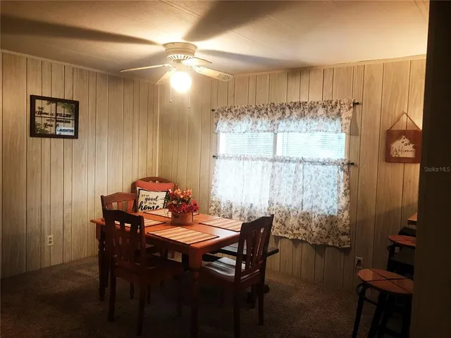 a view of a dining room with furniture and window