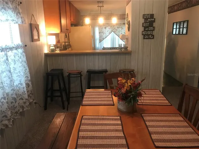 a view of a balcony with chairs and wooden floor