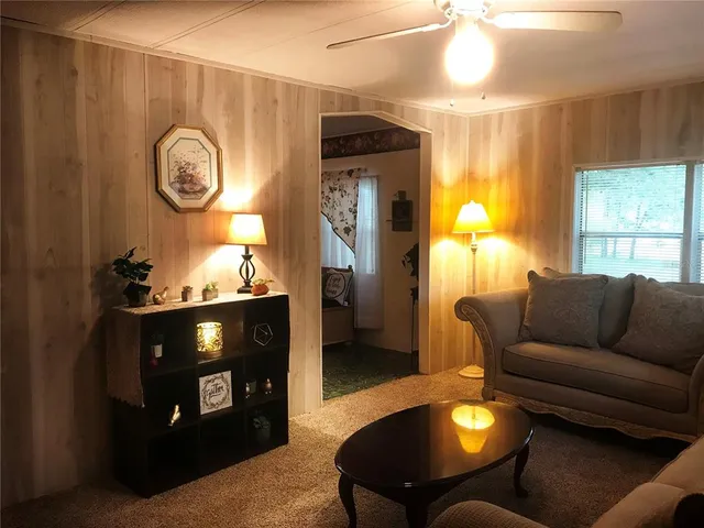 a living room with furniture a window and a fireplace