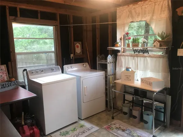 a room with a table chairs and a window