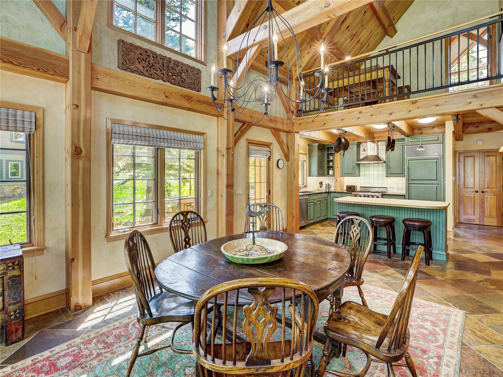 840 Penstemon Road Keystone, CO 80435 - Photo 10 of 50 Dining area featuring high vaulted ceiling, beamed ceiling, a chandelier, and stone tile floors