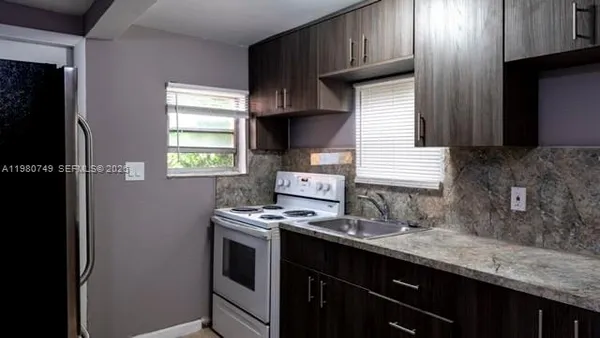 a kitchen with sink cabinets and window