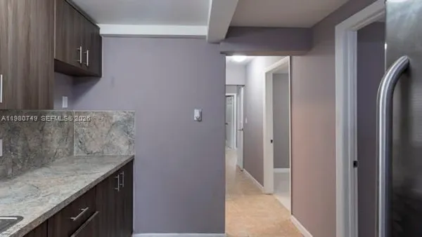 a bathroom with a granite countertop sink a mirror and a shower