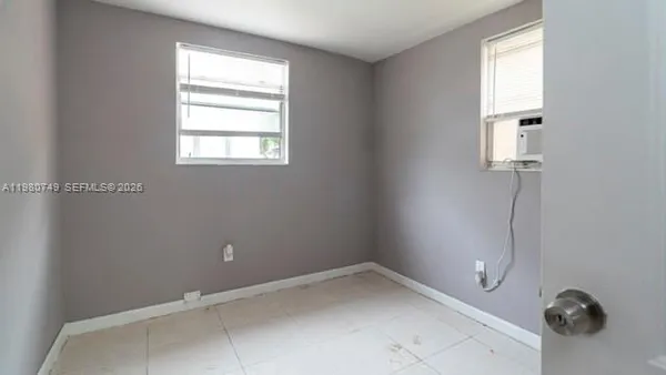 a view of an empty room with a kitchen