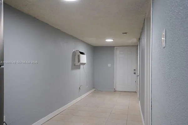 a room with a refrigerator and cabinets